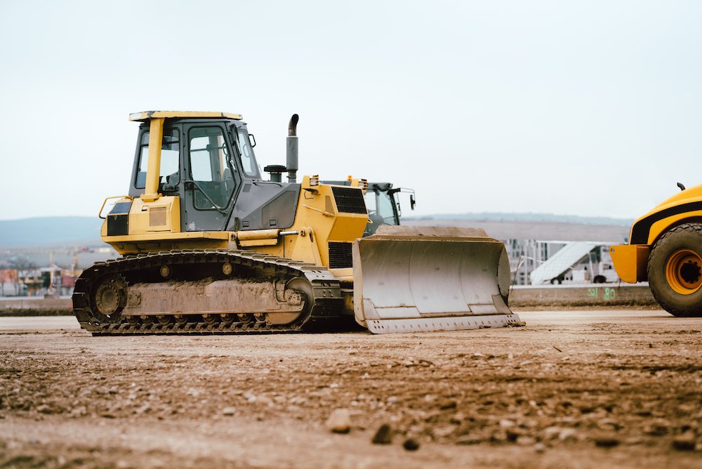 bulldozer is moving dirt on a construction site